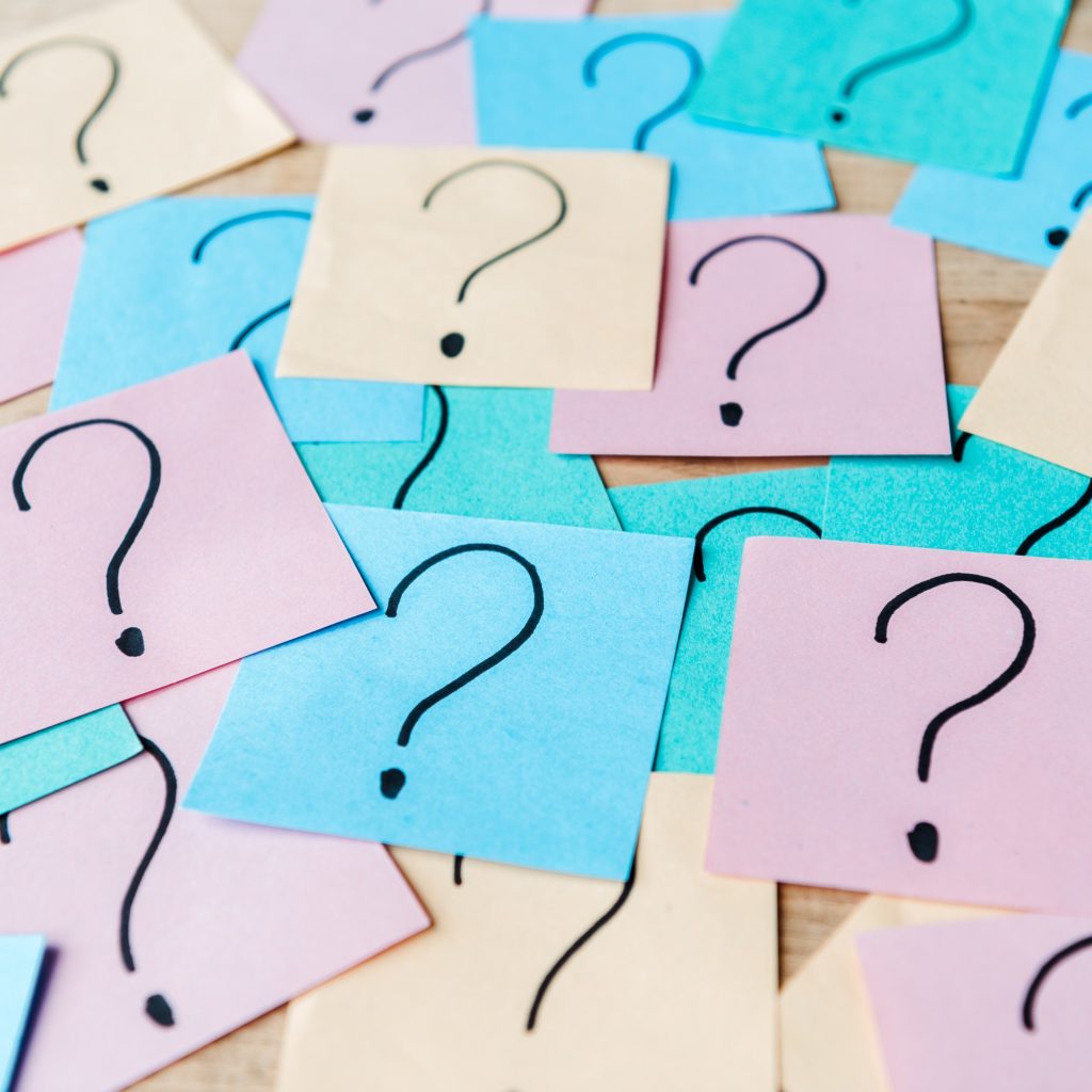 close up of question marks on colorful sticky notes
